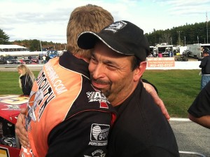 Team owner Gary Casella hugs driver Rowan Pennink after Pennink clinched the team's first Valenti Modified Racing Series championship Sunday at Lee USA Speedway 